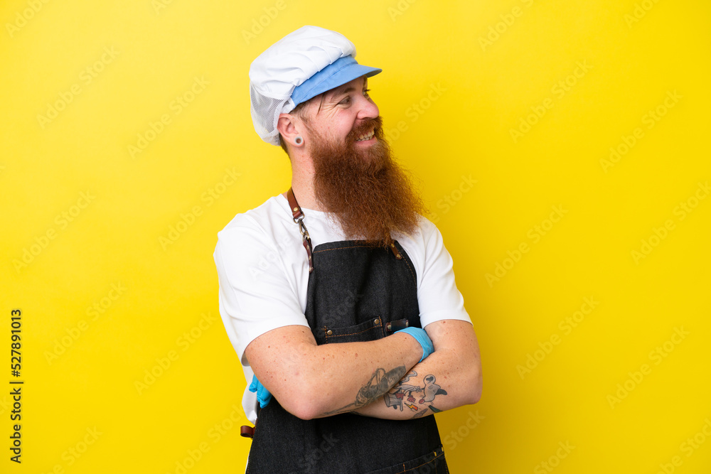 Fishmonger wearing an apron isolated on yellow background with arms crossed and happy