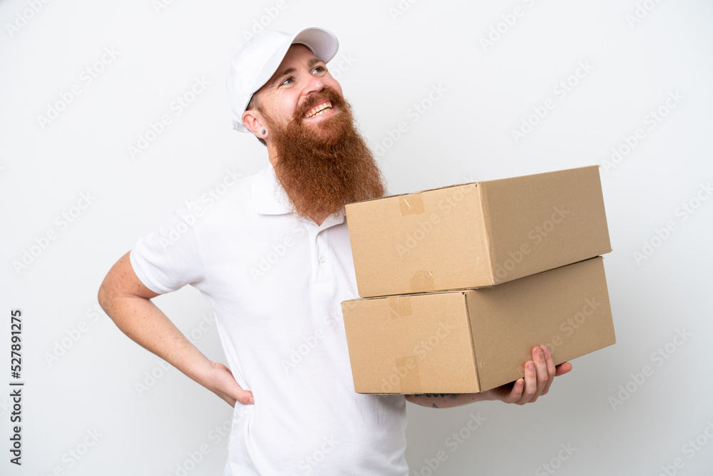 Delivery reddish man isolated on white background posing with arms at hip and smiling Delivery reddish man isolated on white background posing with arms at hip and smiling