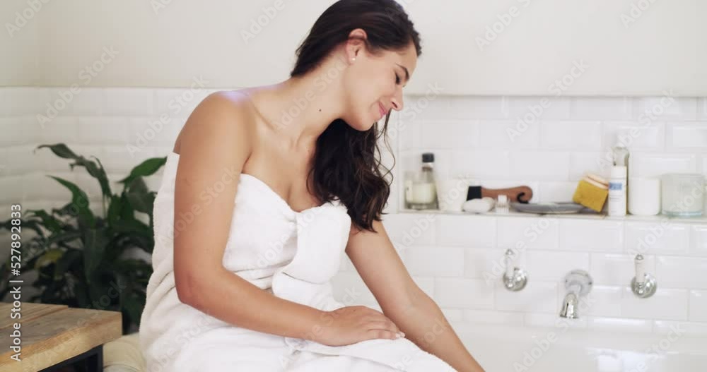 Calm bath for a happy woman to relax in a modern, luxury and white bathroom at home. Lady with a wellness, health and selfcare lifestyle doing a daily bodycare, skincare and beauty routine. Calm bath for a happy woman to relax in a modern, luxury and white bathroom at home. Lady with a wellness, health and selfcare lifestyle doing a daily bodycare, skincare and beauty routine.