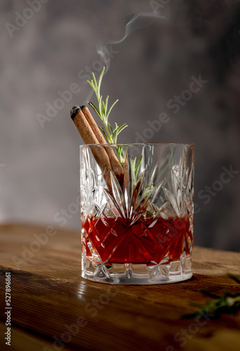 Bourbon cocktail glass with rosemary, old fashion cocktai ldrink, moody background photo