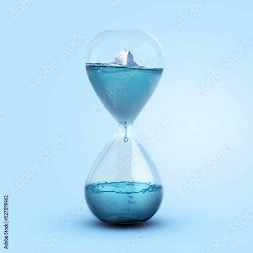 Time and Melting Glaciers, Concept. Iceberg melting in a glass clock. Pollution and global warming, a creative idea