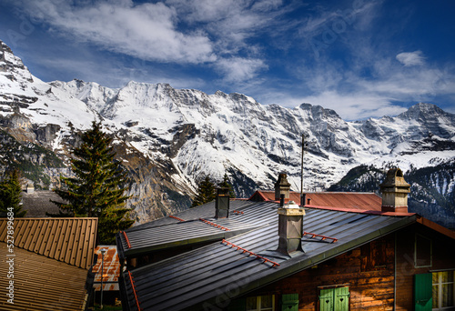 Original name(s): Mountain range of the Bernese Oberland over rooftops of Murren village in the canton Bern, Switzerland photo