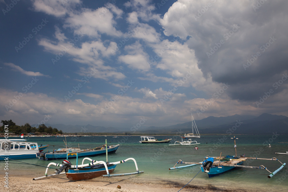 Some traditional Indonesian outrigger fishing boats aground on a Gili Island beach 