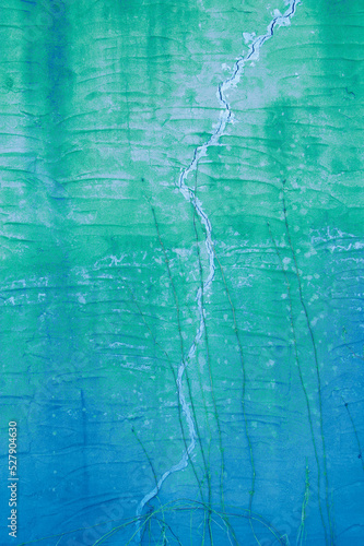 Outdoor stucco wall background, beautiful and calming shades of green and blue.