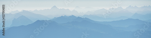 Switzerland, Panoramic view of Foggy mountain summits at dawn, near Santis photo