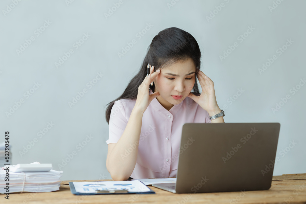 Beautiful Asian woman working with computers in the office of a startup company, she is a company finance employee working in the finance department. Concept of women working in a company. Beautiful Asian woman working with computers in the office of a startup company, she is a company finance employee working in the finance department. Concept of women working in a company.