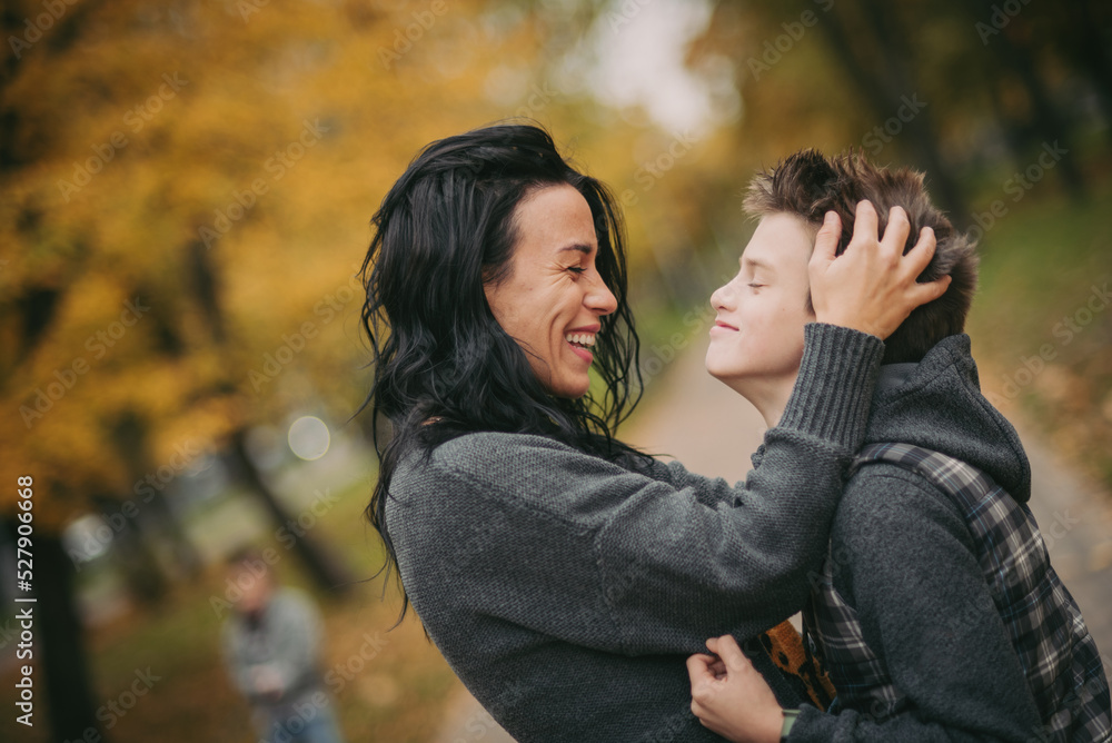 happy family: mother and child cuddling on autumn walk in nature outdoors happy family: mother and child cuddling on autumn walk in nature outdoors