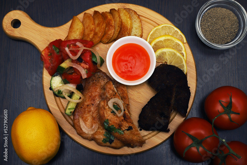 Langet, chop with vegetables on the sides. Shallow depth of field photo