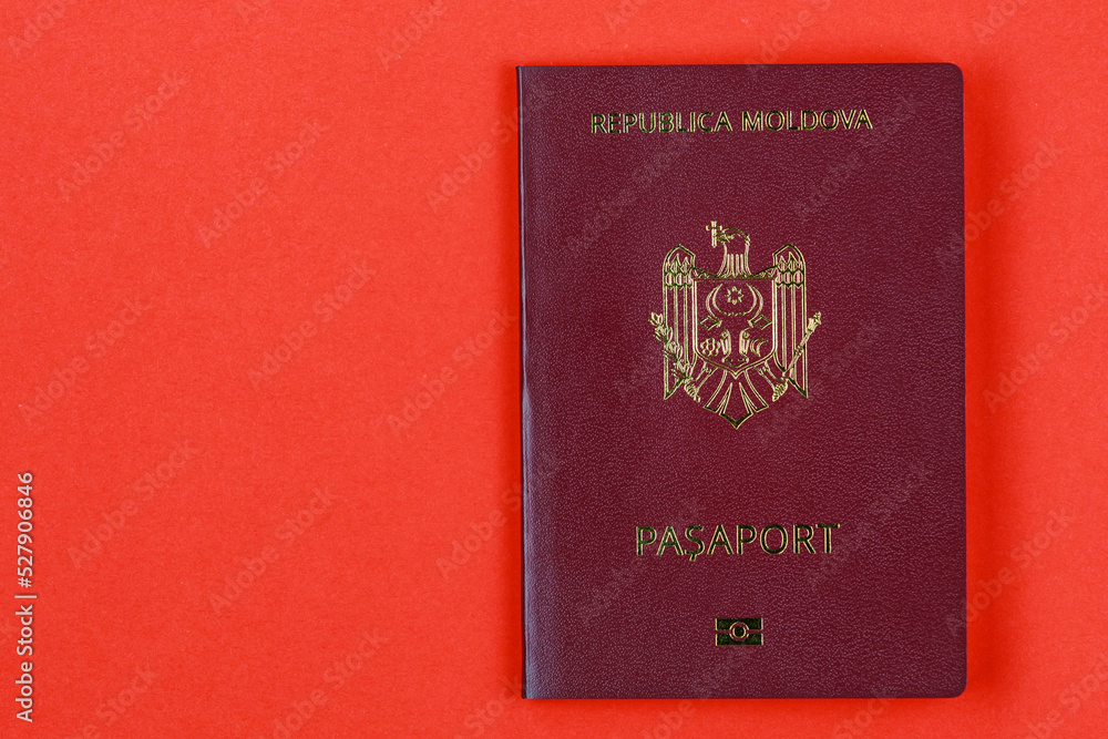 Modern foreign passport of a citizen of the Republic of Moldova. Background with copy space on the left Modern foreign passport of a citizen of the Republic of Moldova. Background with copy space on the left