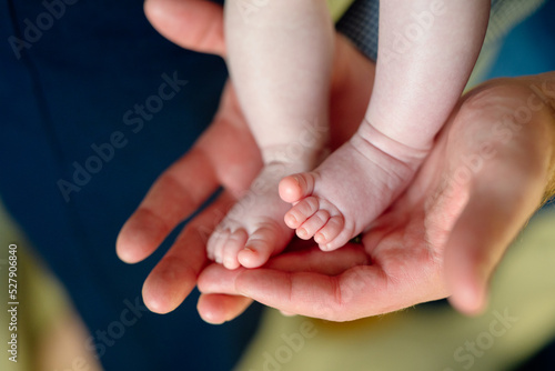 newborn baby feet in parents hands