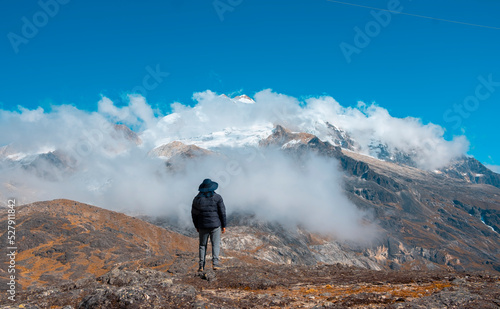 man looking at a mountain in the andes