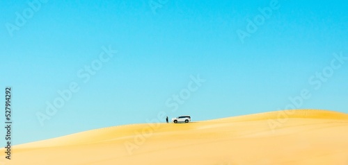 Car on top of sand dune