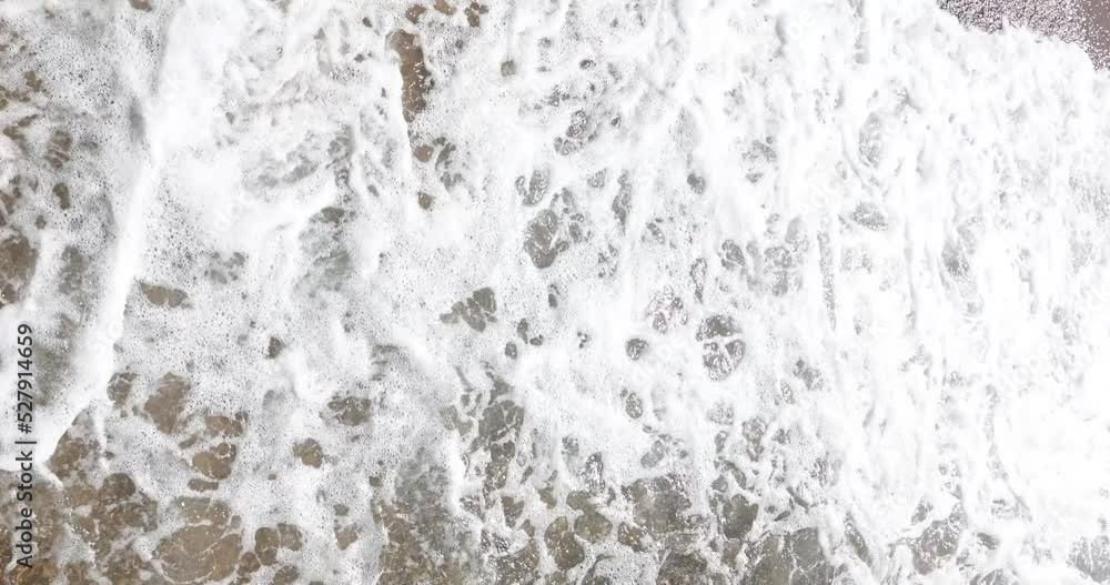 Walking on sea strong waves with foam top view Walking on sea strong waves with foam top view