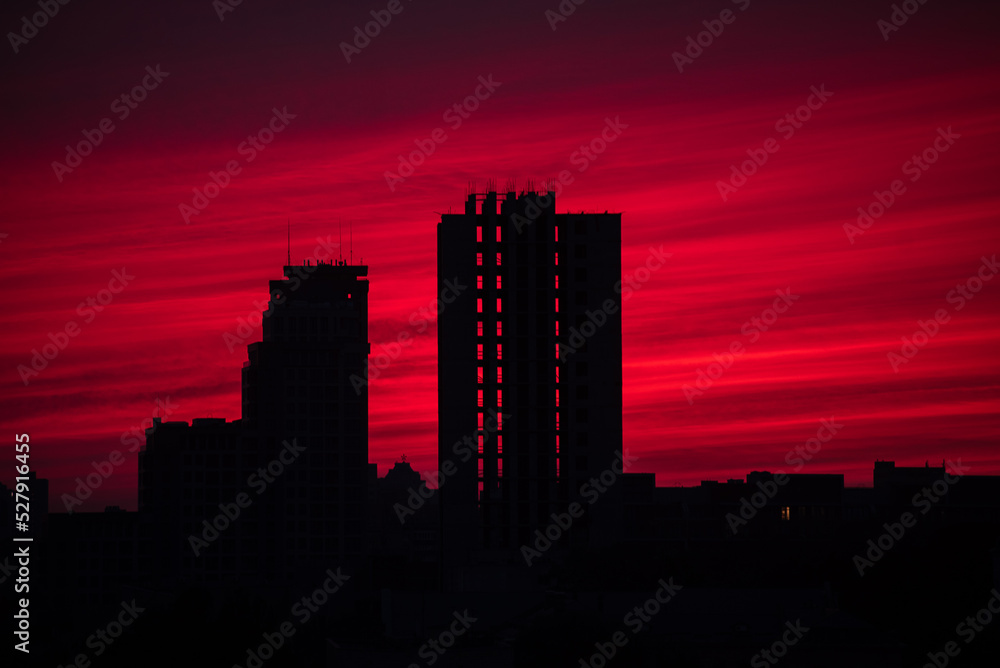 Red sunset over sikhouettes of building