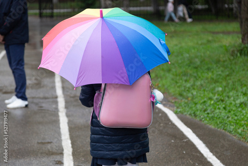 A schoolgirl goes to school.A schoolgirl with an umbrella in the rain.