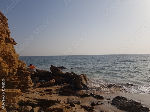 waves hitting Rocks on the shore of the Arabian Sea photo