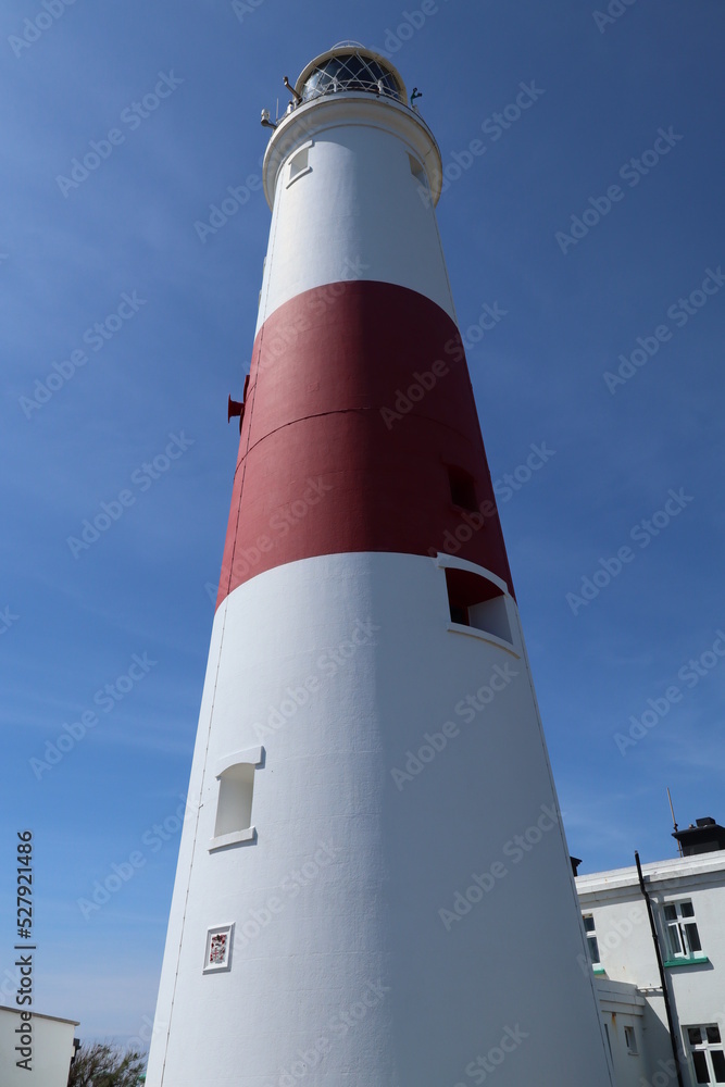 Looking up at the distinctive red and white striped lighthouse at Portland Bill in Dorset, England