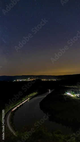 nightscape, night full of stars, milkyway behind a loop or curve of the river Saar close to the city Saarburg in Rheinland-Pfalz, Germany
