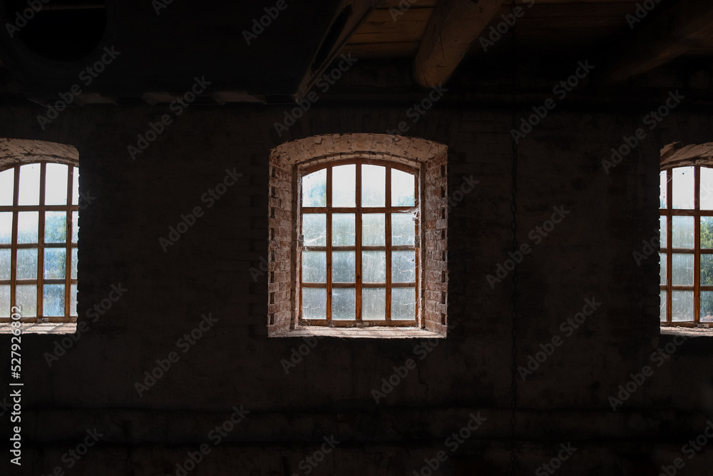 Fototapeta premium Medieval windows in old building as an dark architectural background