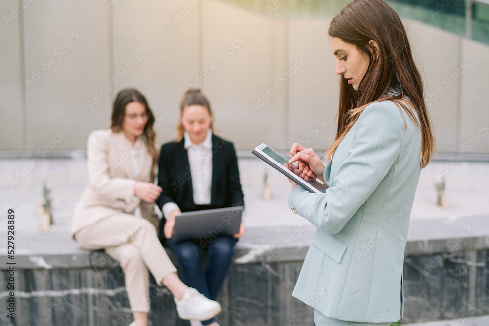 Businesswoman using tablet in city center Businesswoman using tablet in city center