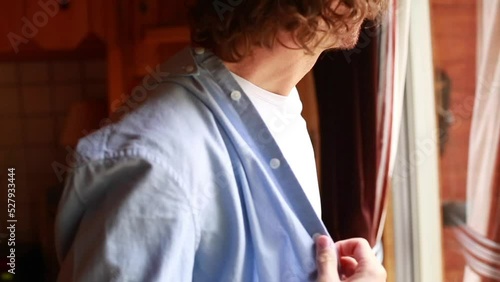 Groom getting ready for elopement wedding in the woods photo