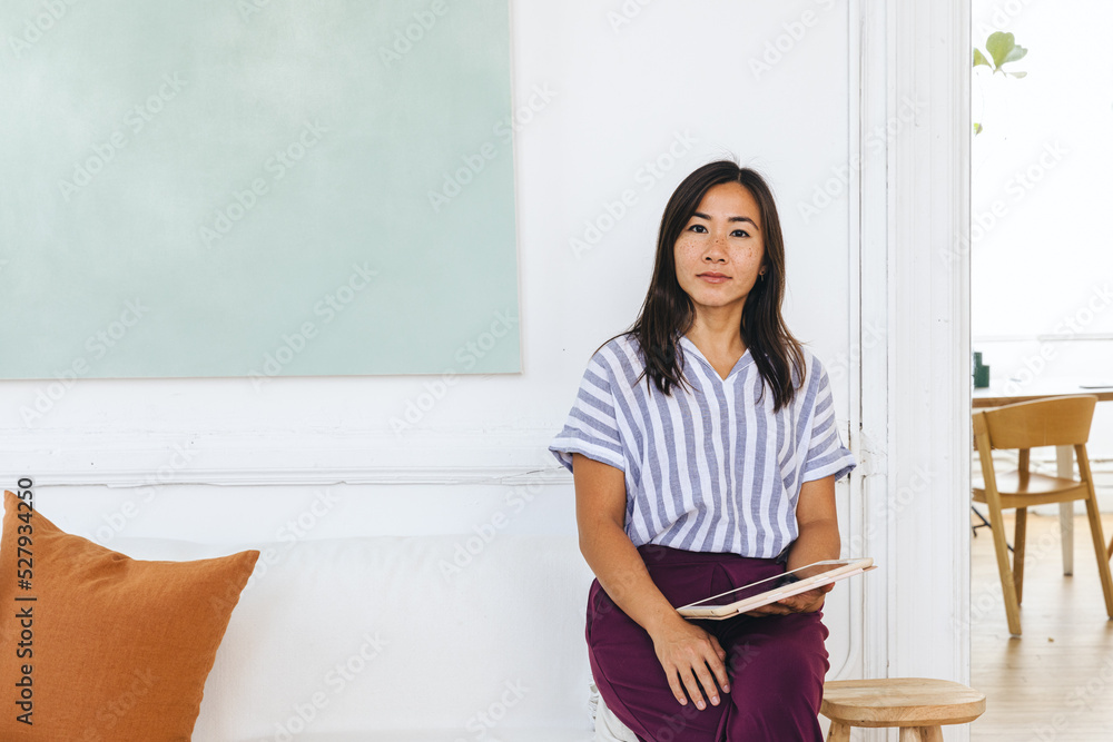 Portrait of confident businesswoman with digital tablet sitting Portrait of confident businesswoman with digital tablet sitting