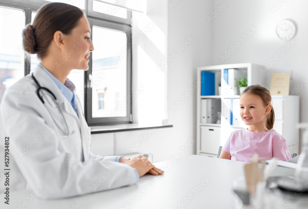 medicine, healthcare and pediatry concept - female doctor or pediatrician talking to happy smiling little girl patient on medical exam at clinic medicine, healthcare and pediatry concept - female doctor or pediatrician talking to happy smiling little girl patient on medical exam at clinic