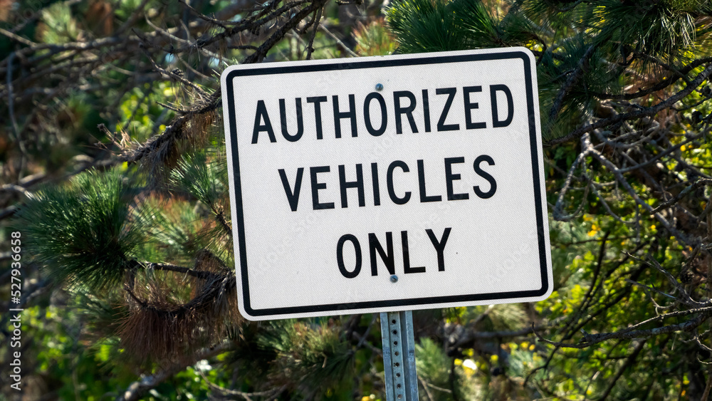 Authorized Vehicles Only street sign on country road. Authorized Vehicles Only street sign on country road.