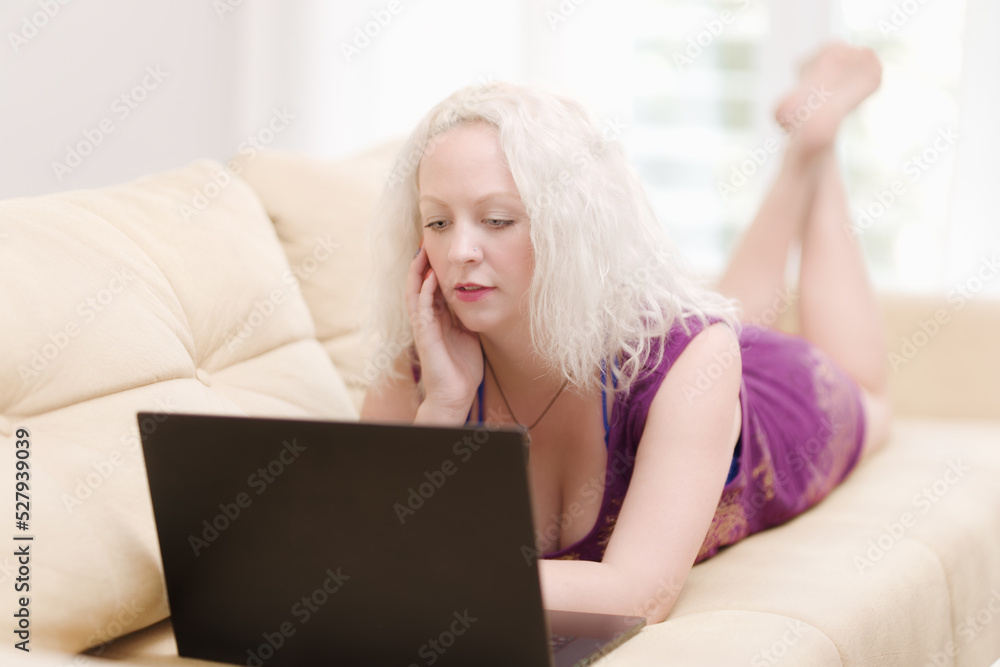 Thoughtful blond woman reading email on the laptop Thoughtful blond woman reading email on the laptop