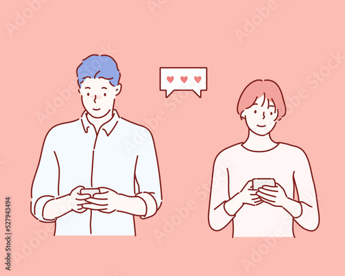 Cheerful young couple standing isolated over pink background, holding smart phones in casual wear. Hand drawn style vector design illustrations.