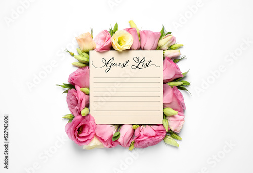 Guest list and beautiful flowers on white background  top view