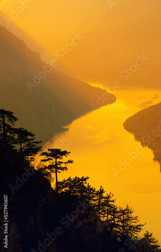 Beautiful landscape showing mountains  valley and river on a sunny summer day 