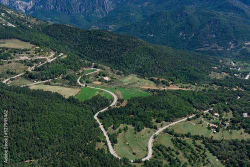 View from above of a winding road in the middle of nature photo