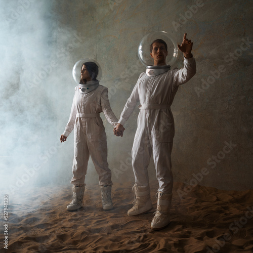 Obraz na plátně Astronauts in an empty colony on a deserted planet, a man and a woman in white f