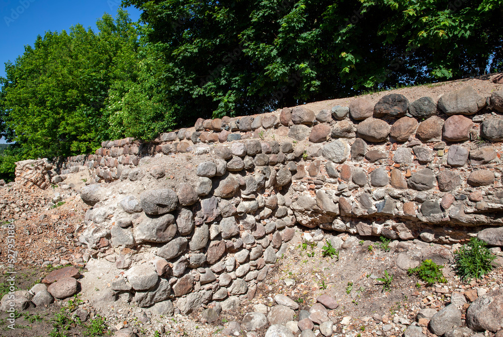The old wall of the building is made of stones and cobblestones