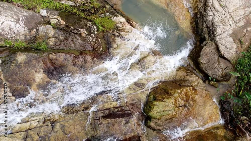 Aerial view water fall from the top of granite stone Aerial view water fall from the top of granite stone