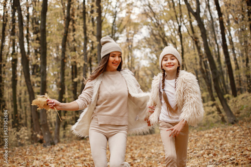 Mother and her daughter playing and having fun in autumn forest © prostooleh