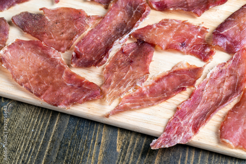 Obraz premium thin pieces of dried meat with spices