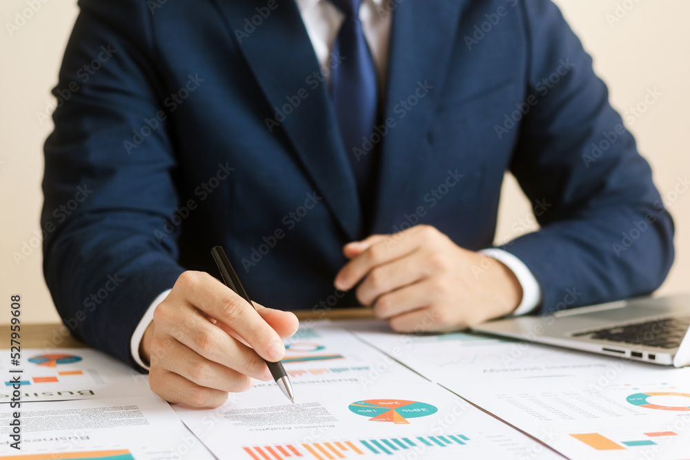 Businessman analyzing financial balance sheet and corporate profit report graph at office, calculating long term investment financial data, economic concept. stock market research and banking. Businessman analyzing financial balance sheet and corporate profit report graph at office, calculating long term investment financial data, economic concept. stock market research and banking.