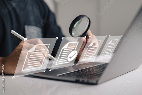 Photography hand using a laptop computer with a virtual screen and document for paperless quality assurance and ERP management concept for online approval