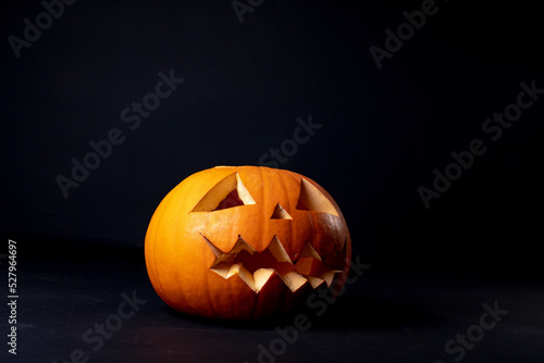 Composition of halloween jack o lantern and copy space on black background