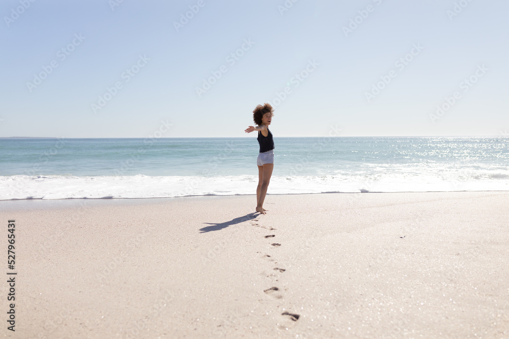 Mixed race woman standing on the beach