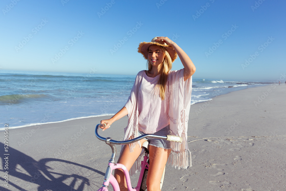 Caucasian woman spending time seaside and riding a bike Caucasian woman spending time seaside and riding a bike
