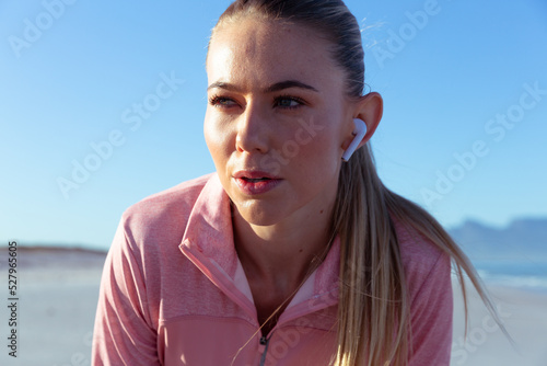 Caucasian woman breathing fresh air seaside after practicing 