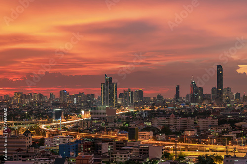 A beautiful twilight sky with a city in the background. © Waraphorn Aphai