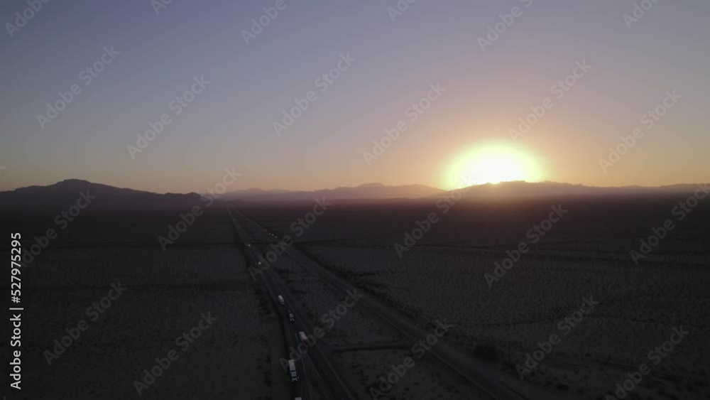 Aerial view of the sunset in California. Traffic on highway in the evening with beautiful background, Mountains and deserts. Aerial view of the sunset in California. Traffic on highway in the evening with beautiful background, Mountains and deserts.