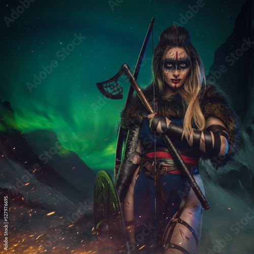 Artwork of antique nordic warrior woman with strup back longbow holding shield and axe.