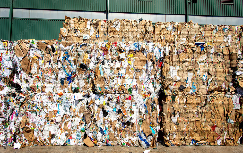 Bales of trash and cardboard at a dump