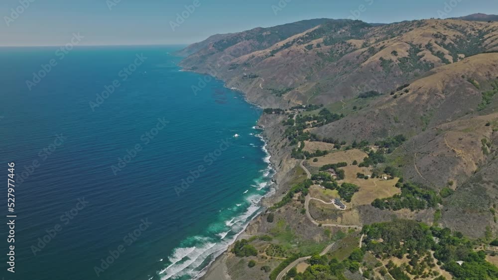 Aerial top view of ocean blue waves break on a coastline Aerial top view of ocean blue waves break on a coastline