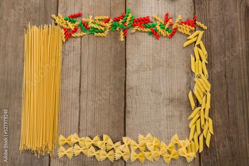 Raw spaghetti and pastas arranged on wooden table